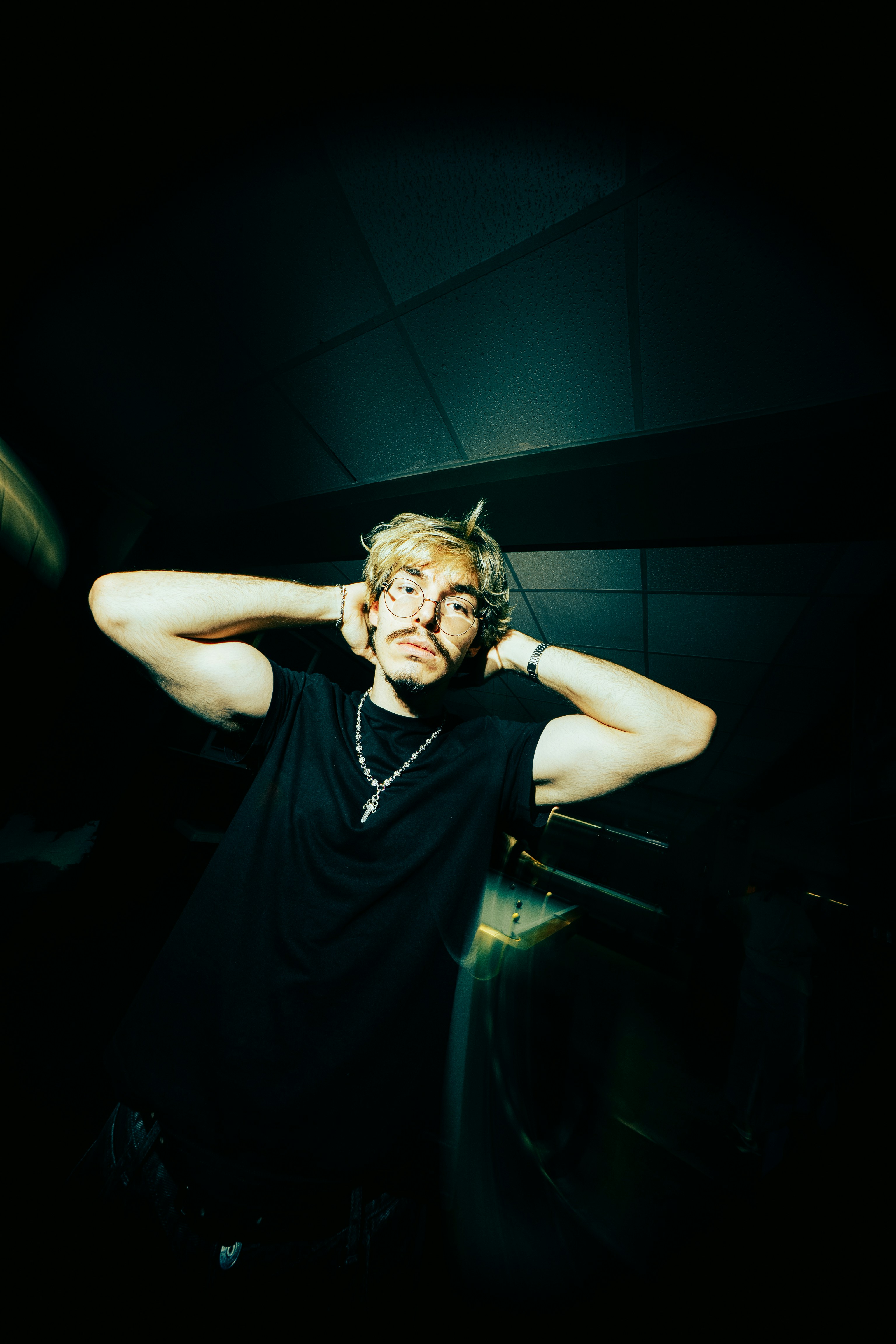 Man With Hands Behind Head In Dark Setting HD mobile wallpaper