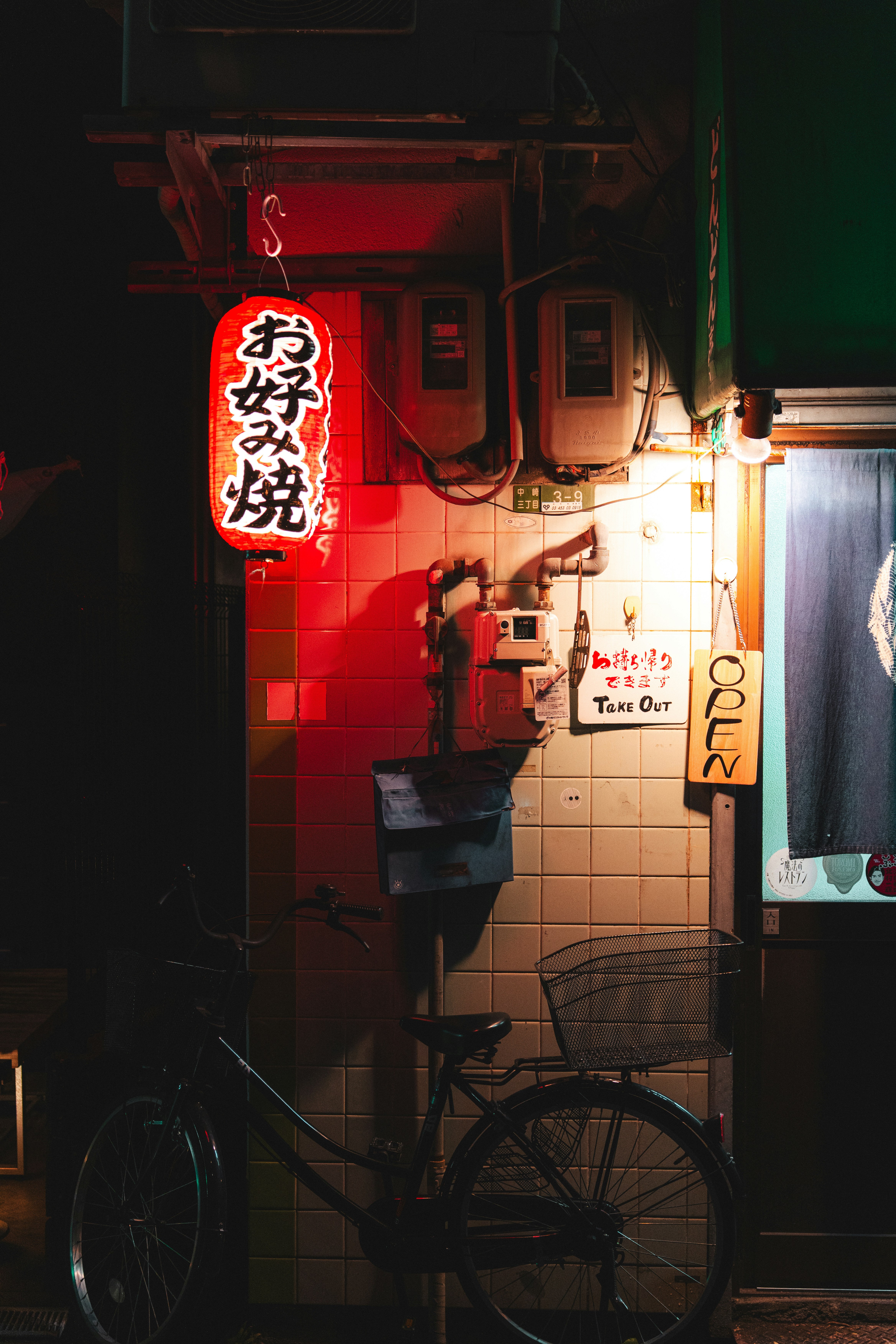 夜色下的红色日本灯笼，照亮停放在建筑外的自行车手机壁纸高清图片