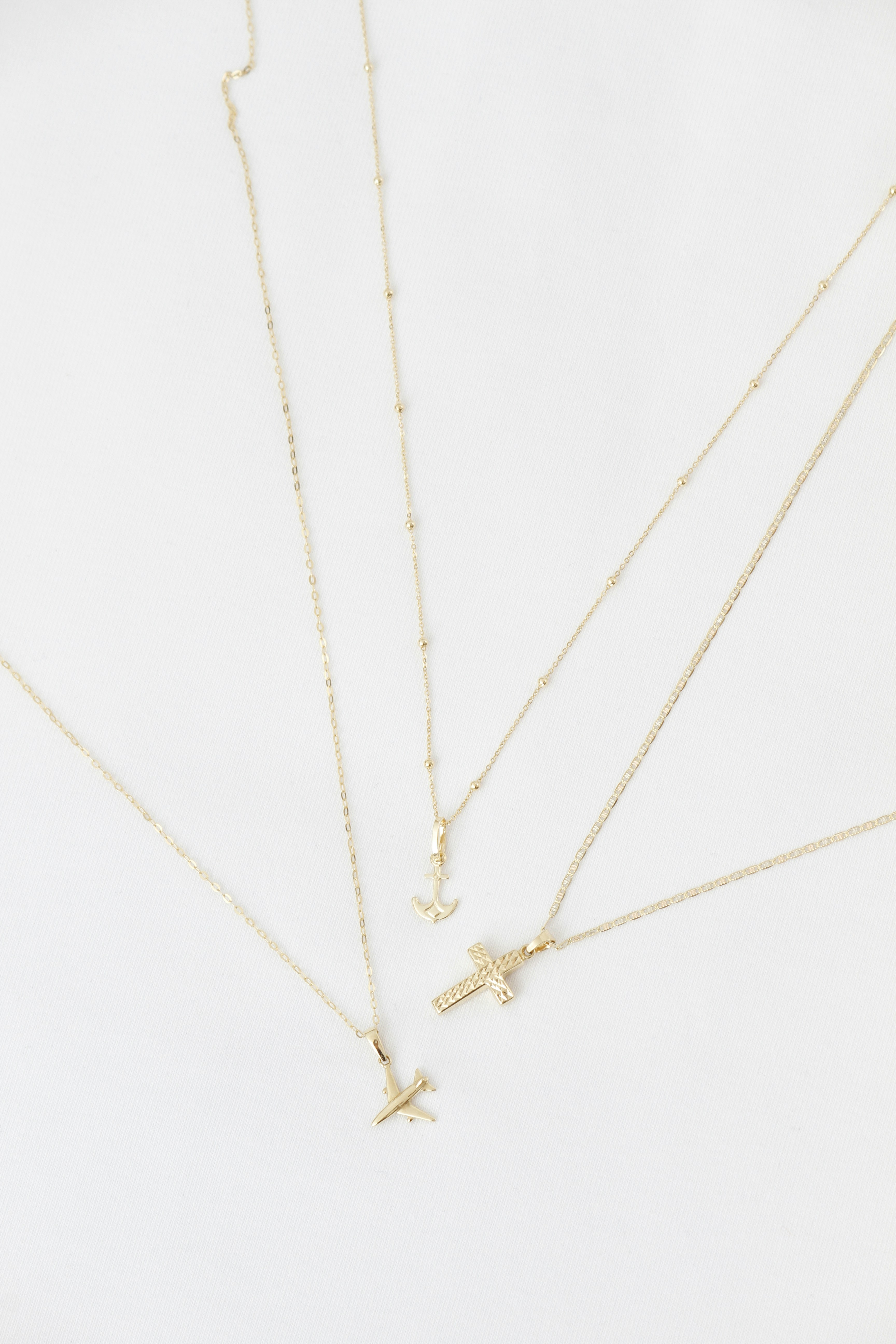 Four Delicate Gold Necklaces With Various Pendants On White Background. HD mobile wallpaper