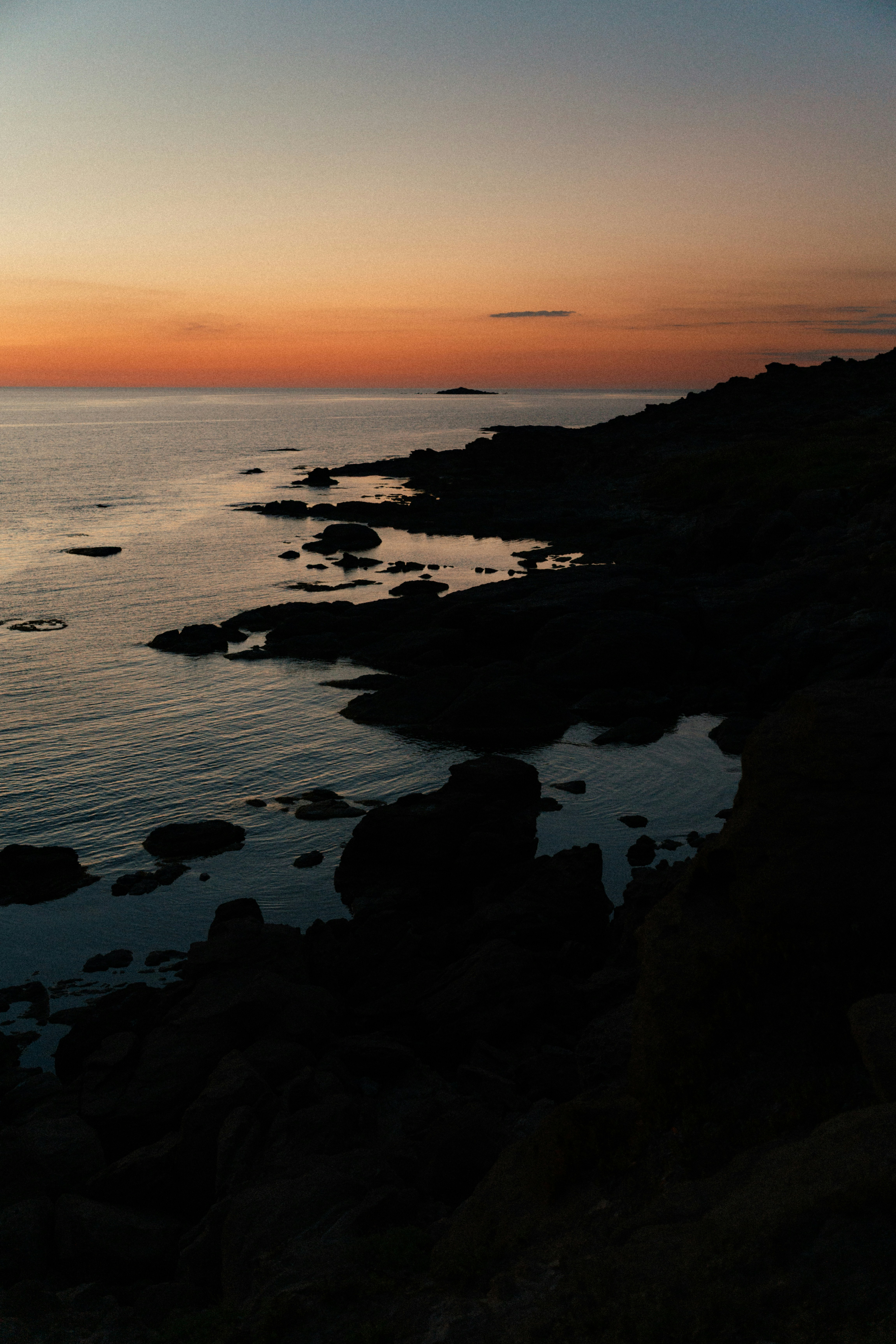 Rocky Coastline At Sunset With A Calm Ocean. HD mobile wallpaper