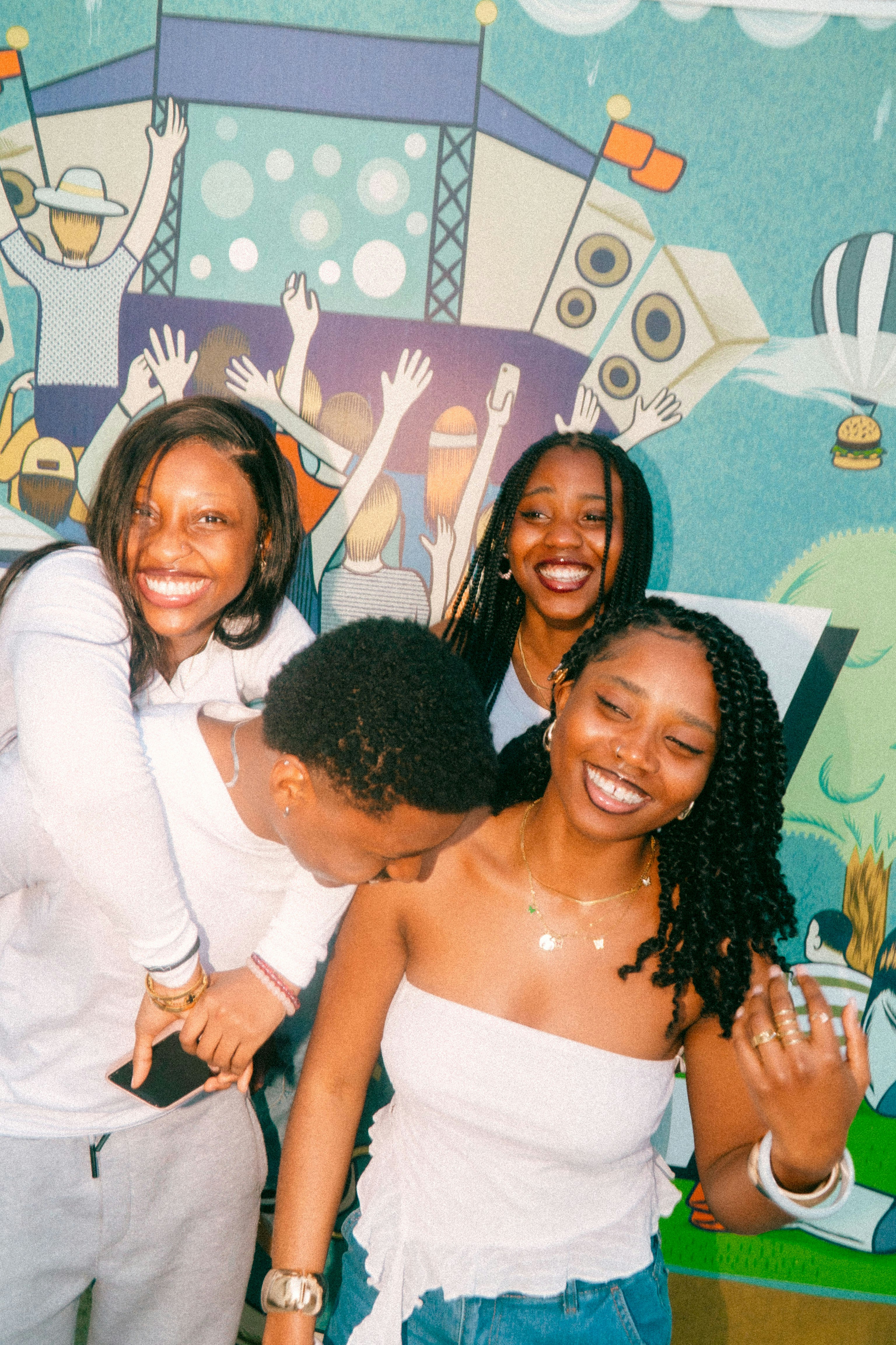 Four Friends Laughing In Front Of A Mural HD mobile wallpaper