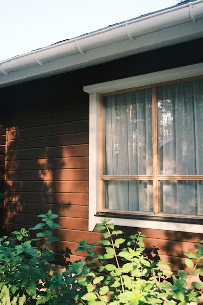 Wooden House Exterior With Window And Green Foliage wallpaper preview