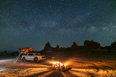 夜空下沙漠星光下的篝火與卡車