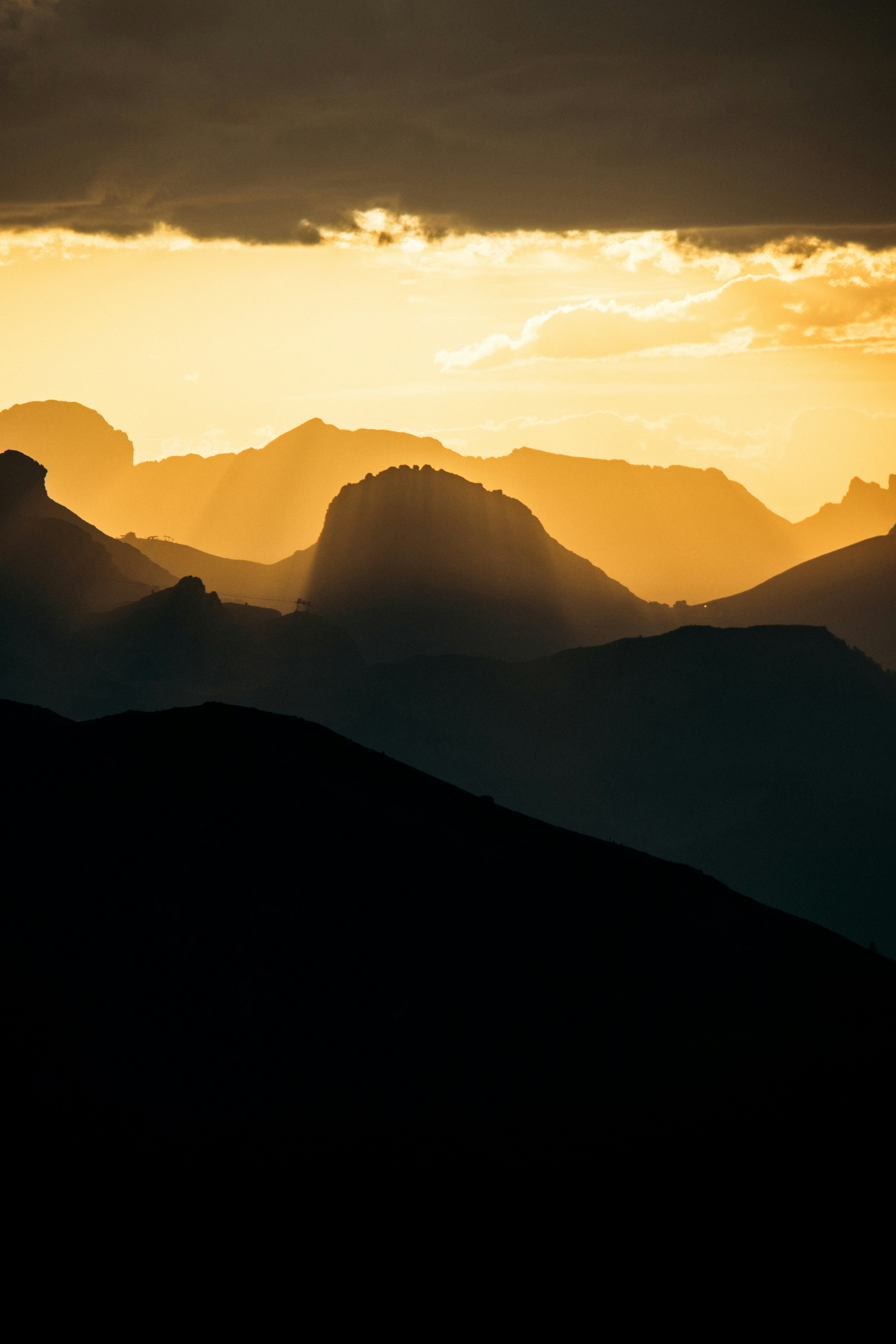 Silhouetted Mountain Ranges At Golden Hour Sunset. HD mobile wallpaper