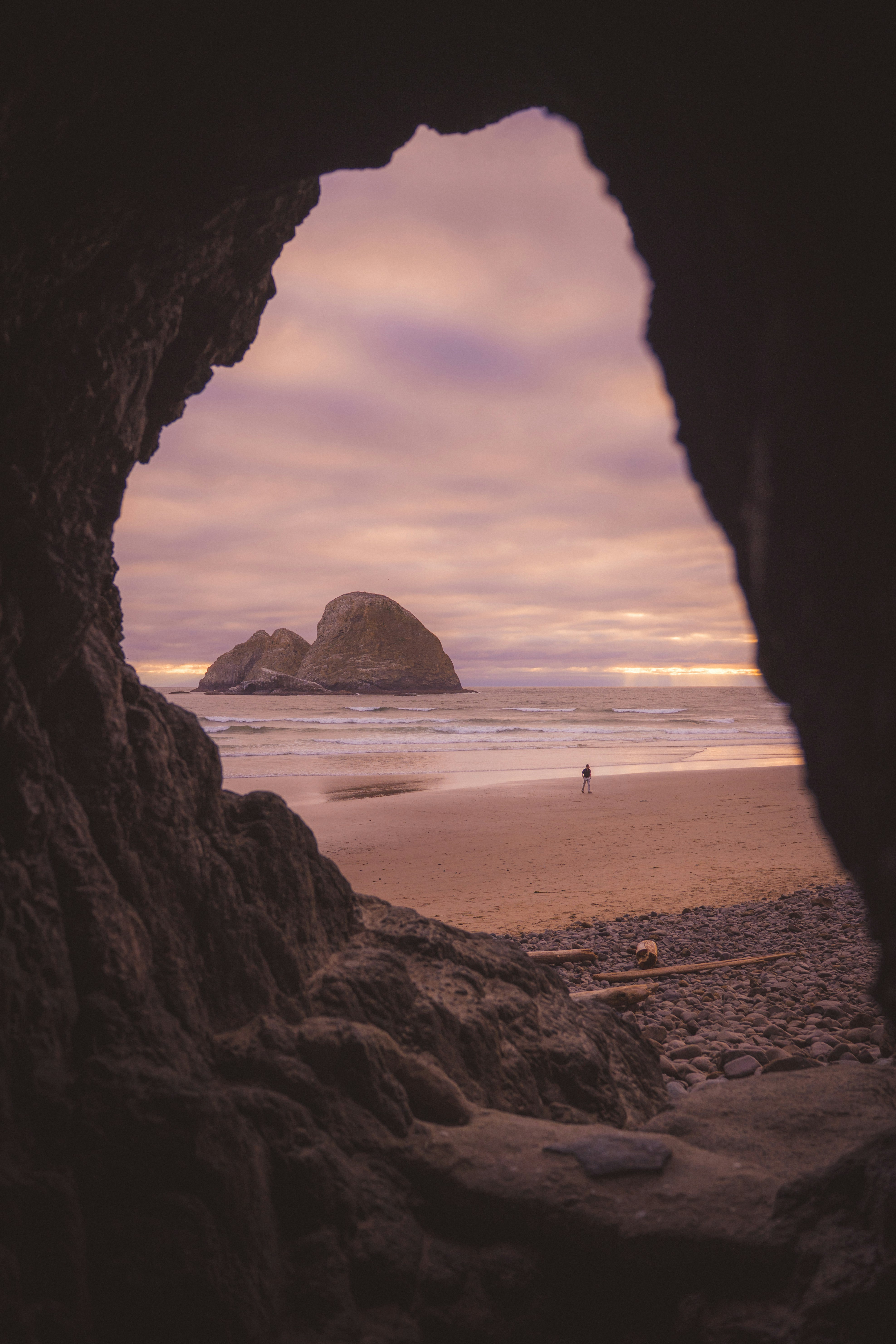 Sea Stack And Beach Visible Through A Dark Cave Opening. HD mobile wallpaper