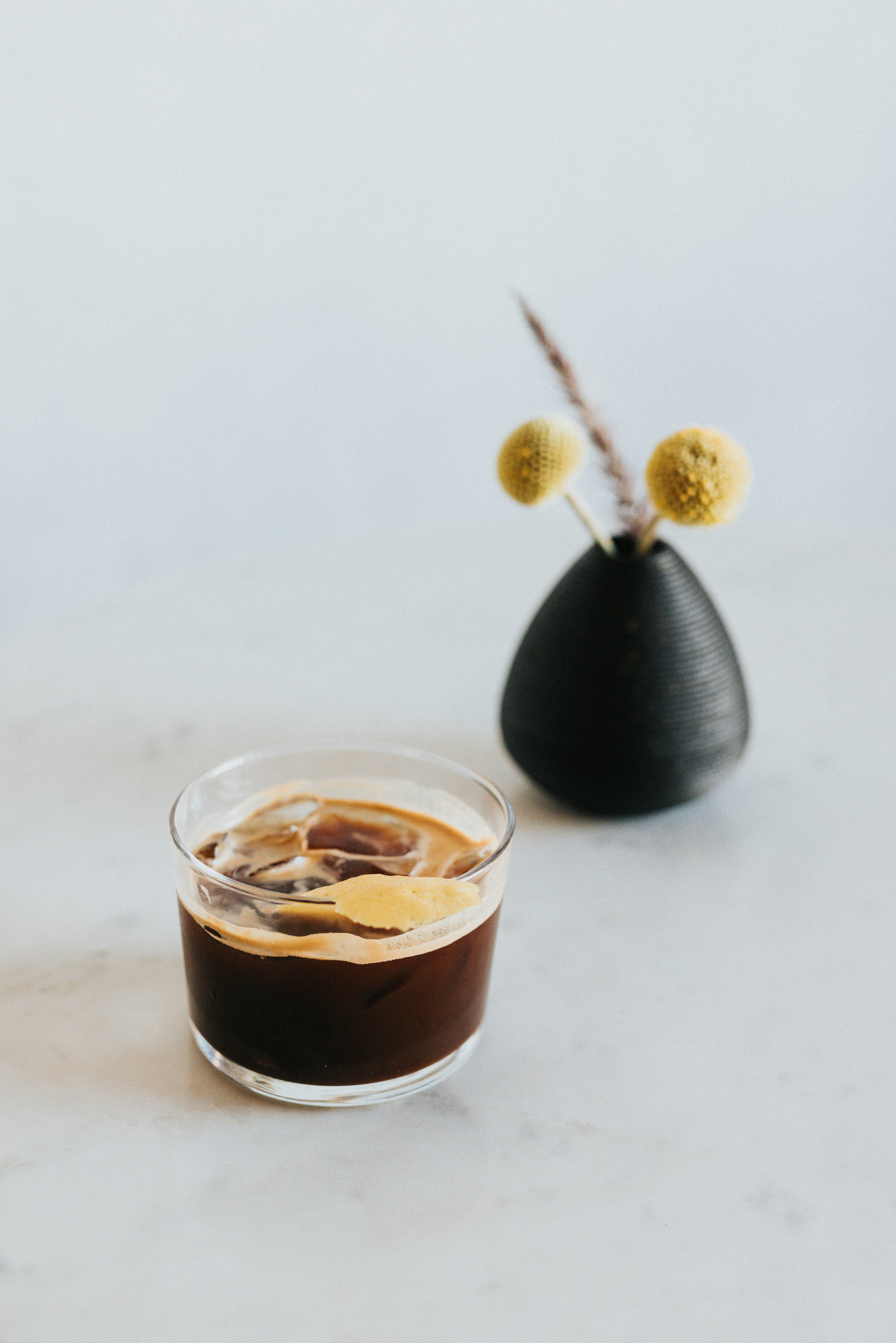 Iced Coffee And A Black Vase With Dried Yellow Flowers. HD mobile wallpaper