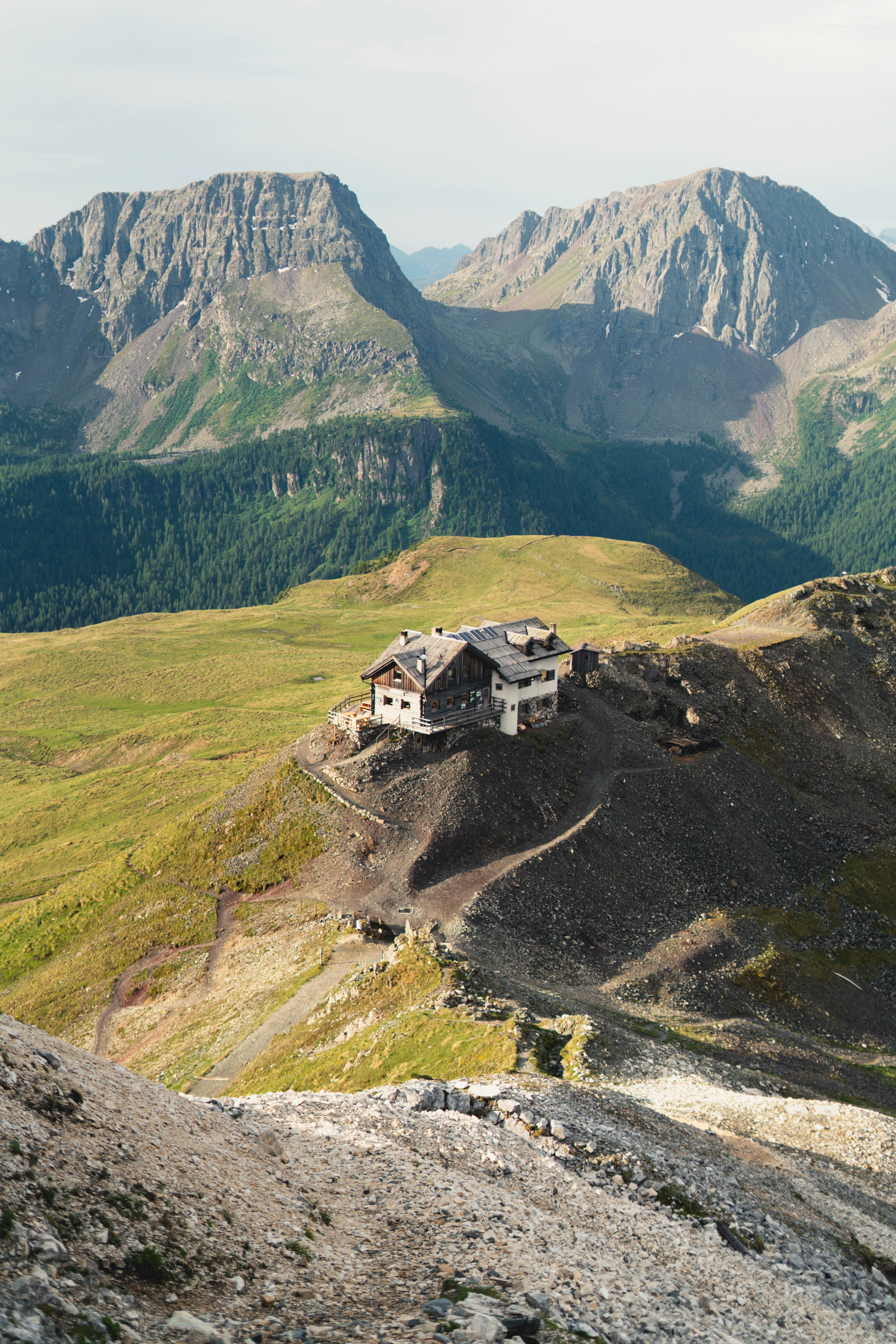 Alpine Hut On A Rocky Mountain Ridge With Distant Peaks. HD mobile wallpaper