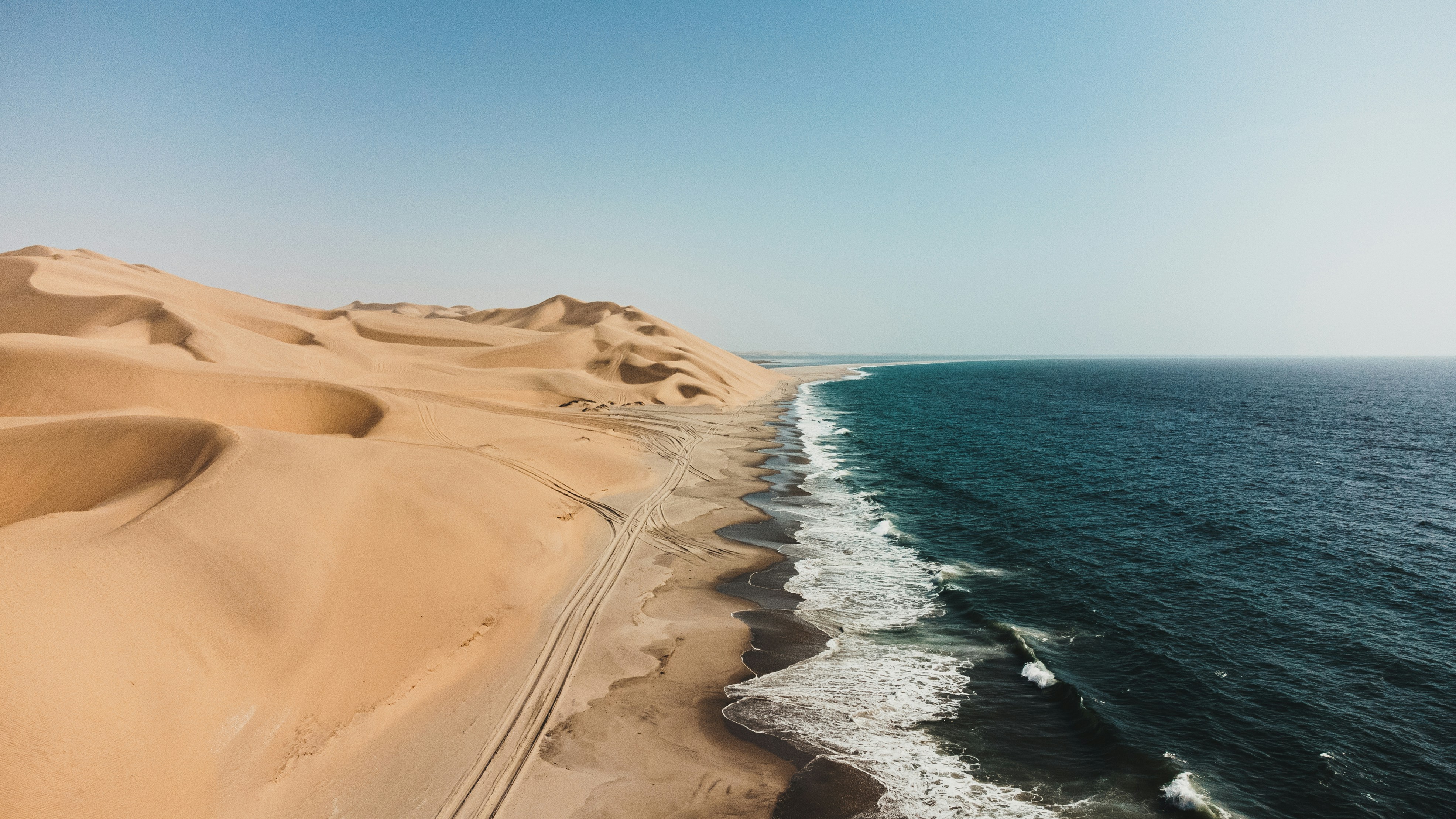 Sandy Desert Dunes Meet The Blue Ocean Waves. HD mobile wallpaper