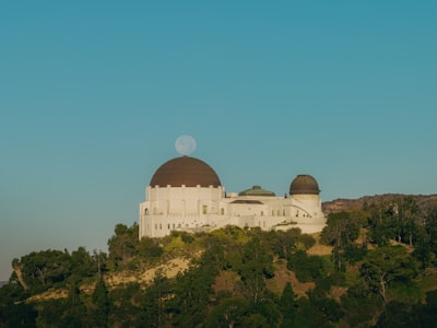 Griffith Observatory Building With Moon Behind Dome wallpaper preview