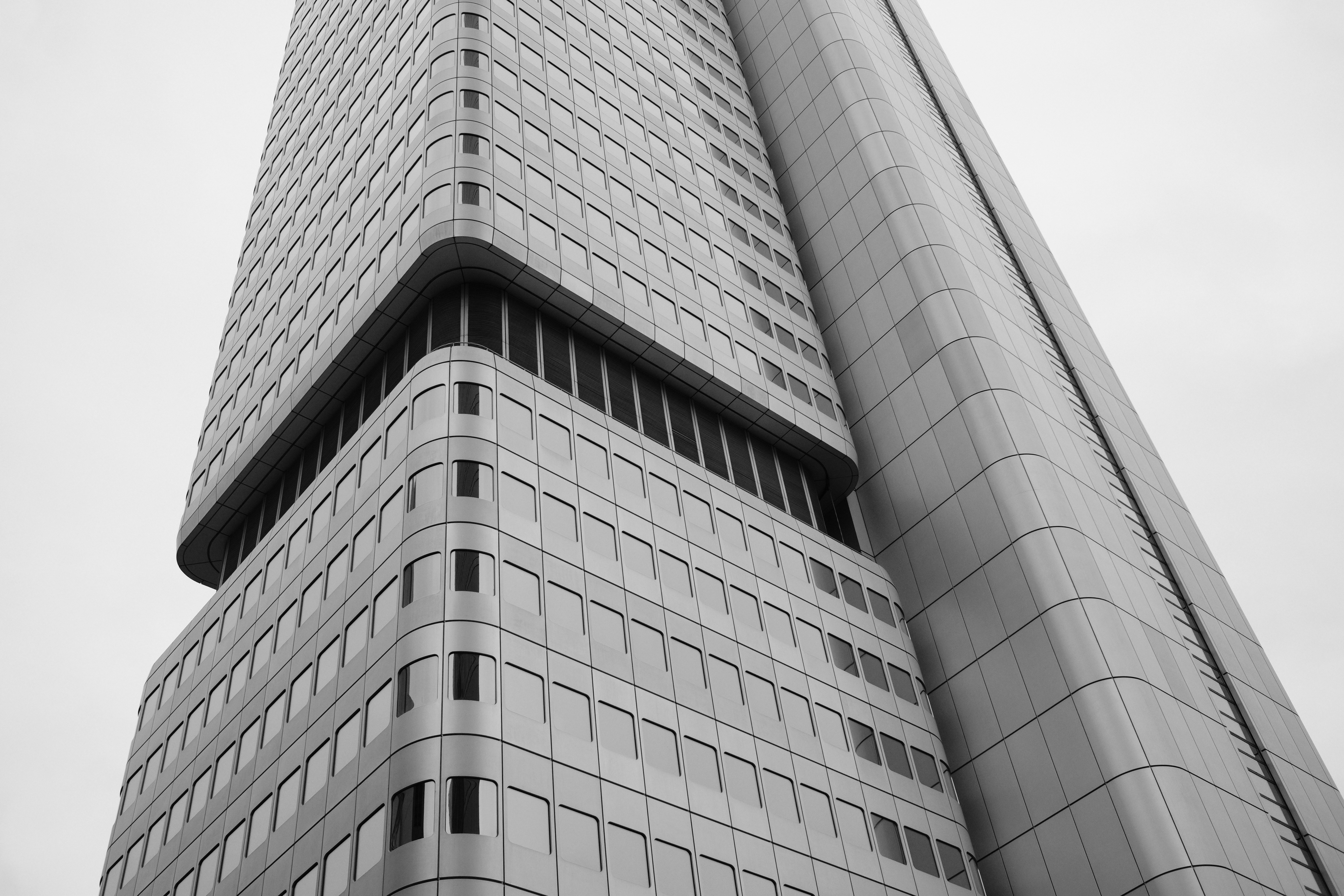 A Low-angle View Of A Modern Skyscraper With A Grid Of Windows HD mobile wallpaper