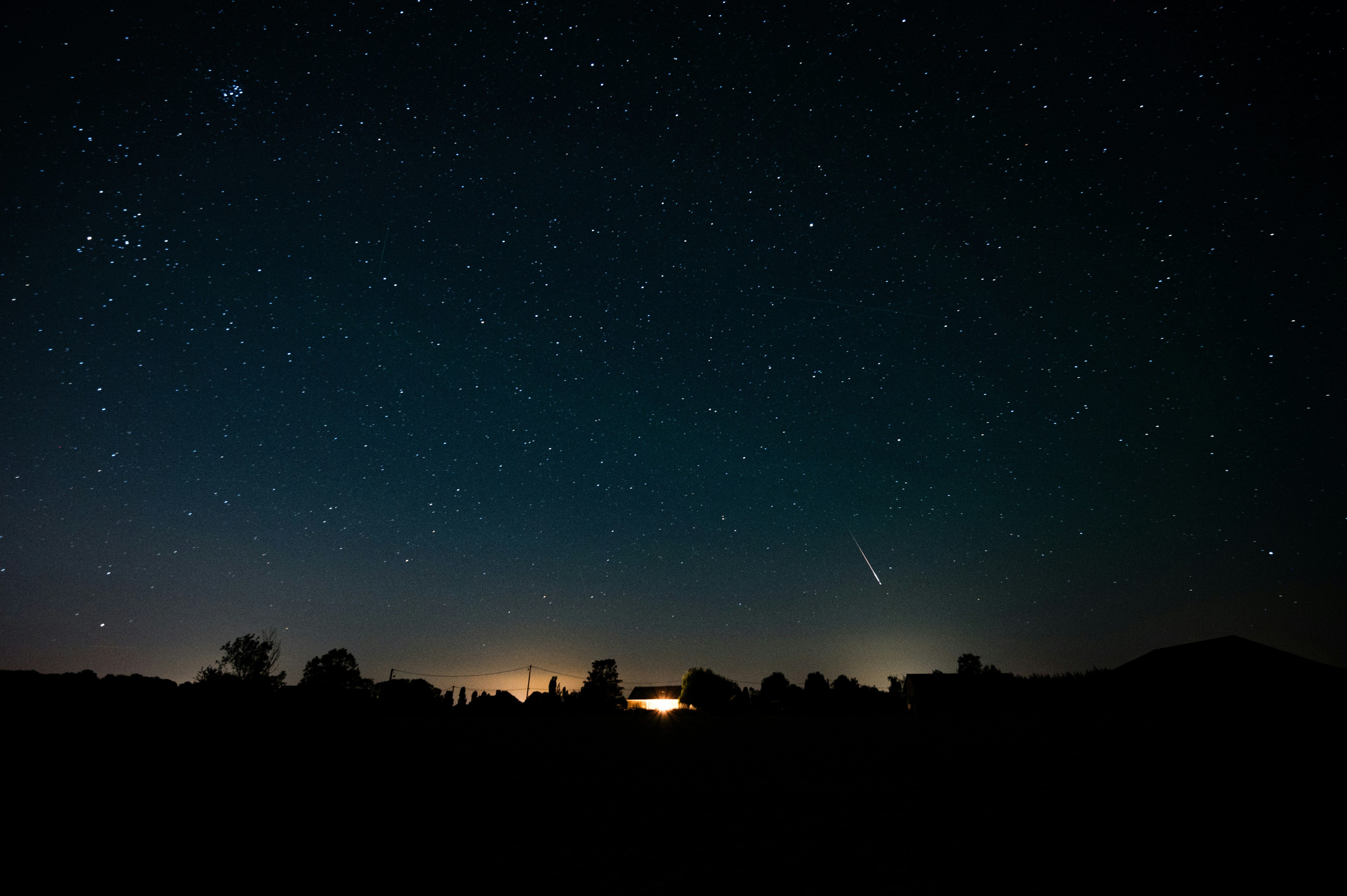 A Beautiful Perseid Meteor Streaks Across A Clear, Starry Night Sky Above A Silhouetted Countryside Landscape In France. HD mobile wallpaper