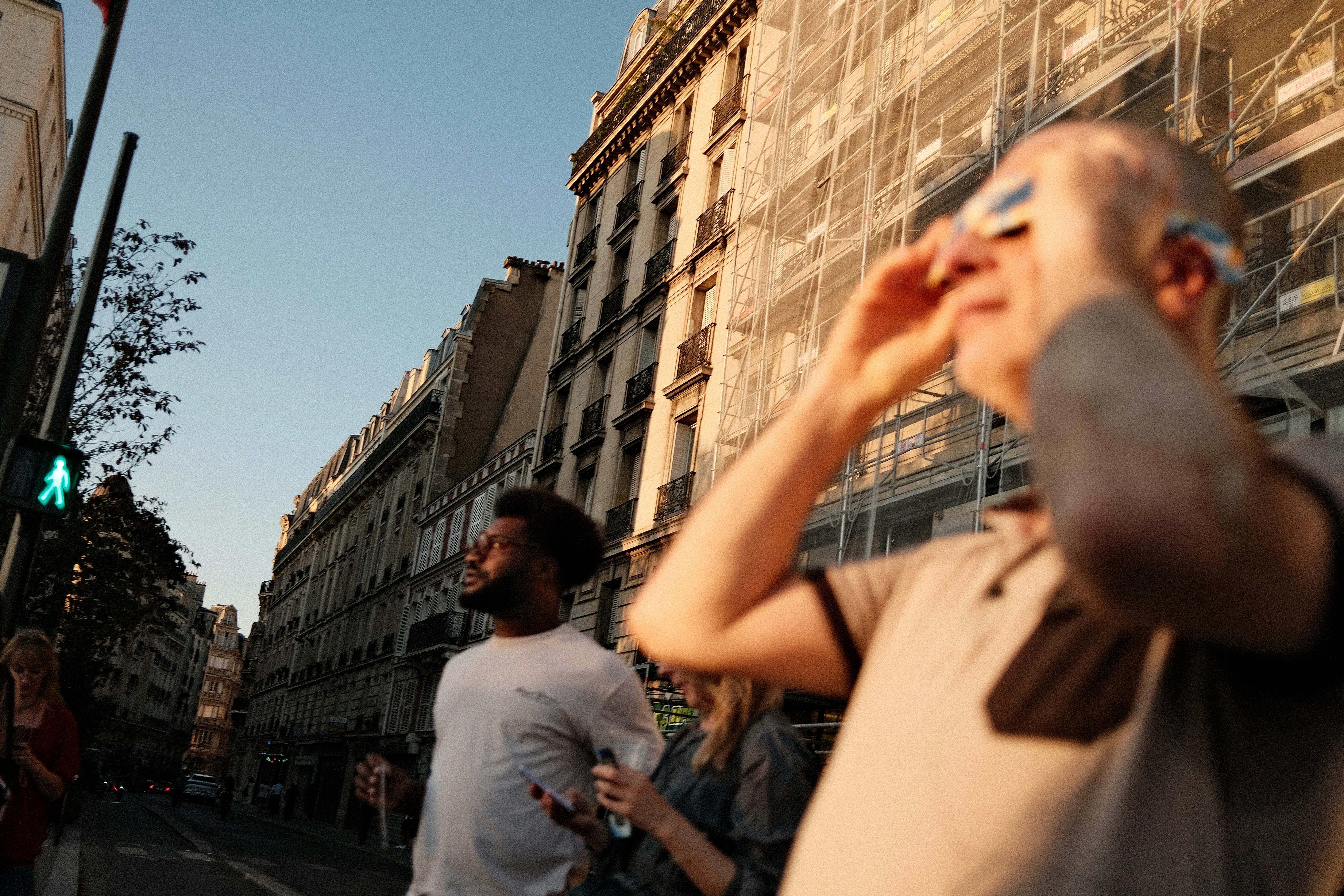 People On A Street In Paris Looking Up At The Sky During Golden Hour. HD mobile wallpaper