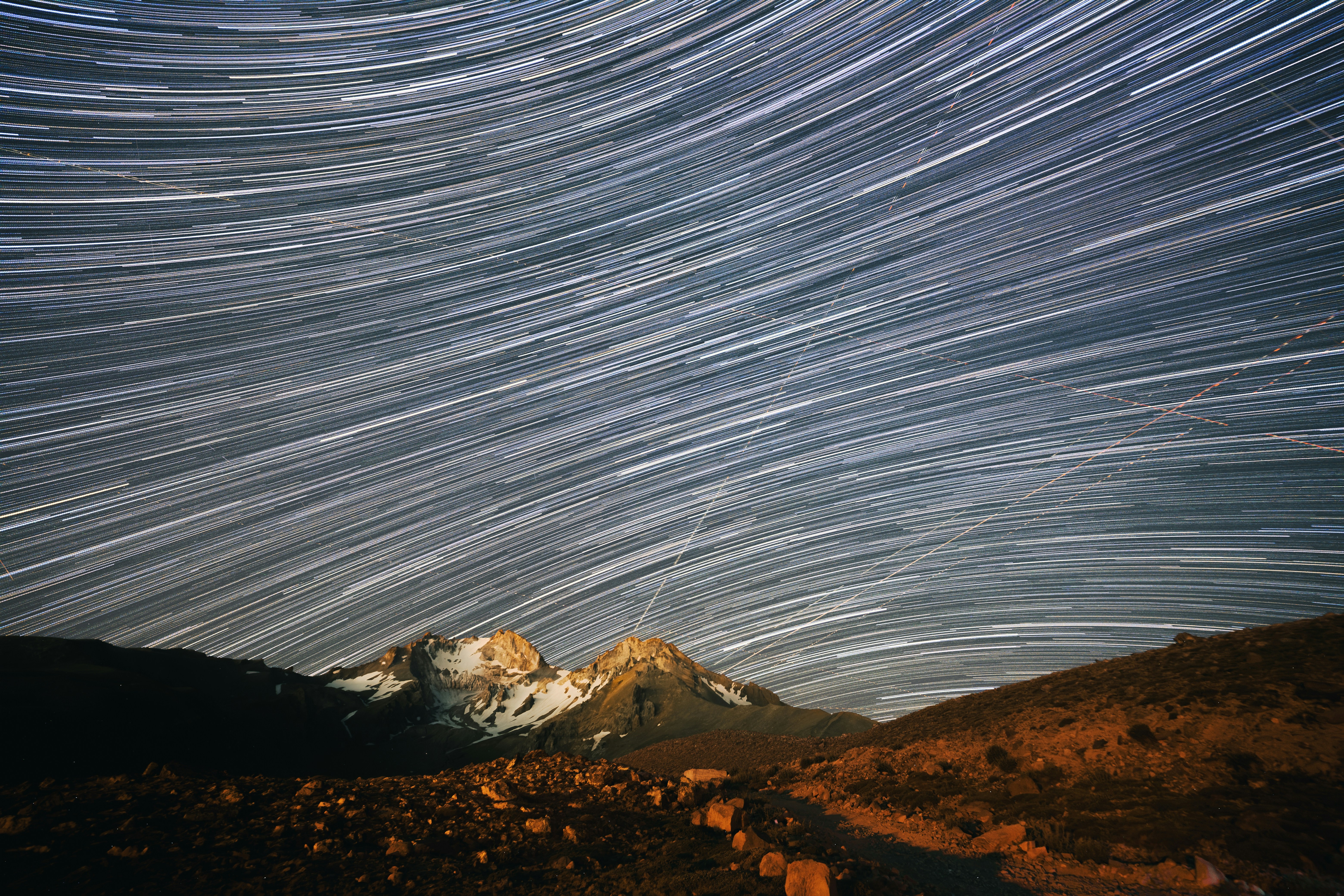 Long Exposure Star Trails Over A Snow-capped Mountain Peak At Night HD mobile wallpaper