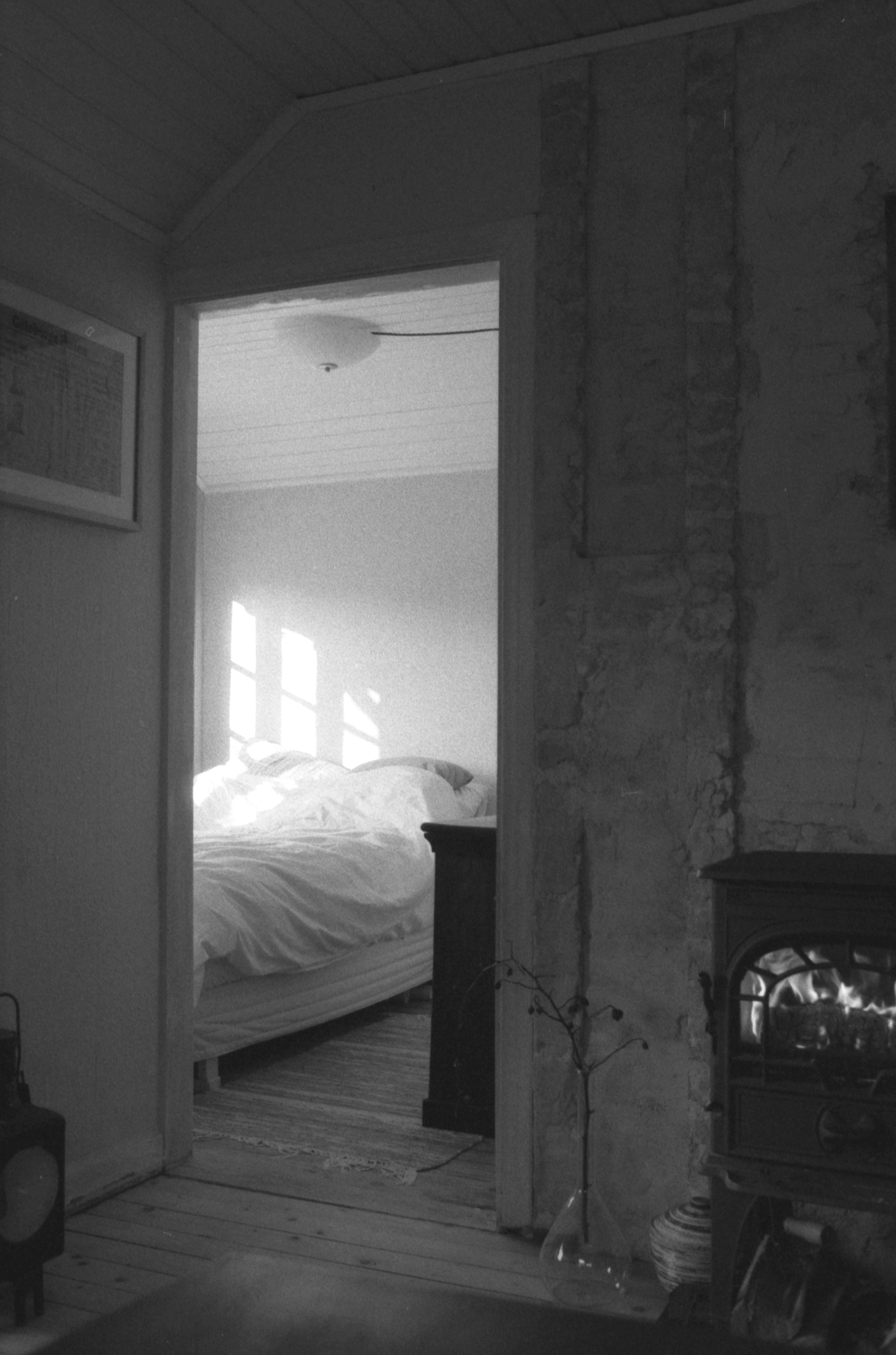 A View Through A Doorway Into A Sunlit Bedroom With A Made Bed HD mobile wallpaper