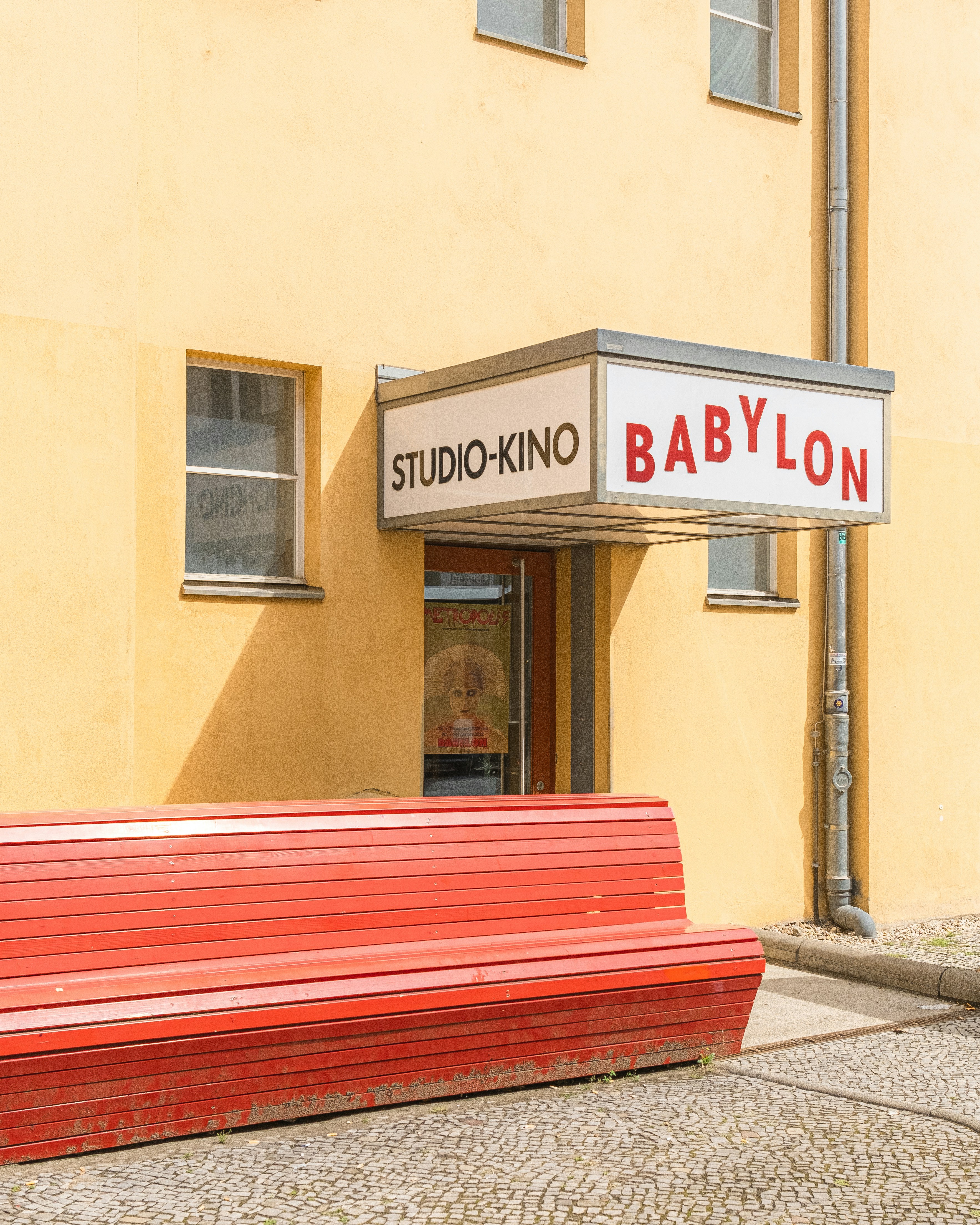 A Red Bench In Front Of The Studio-Kino Babylon Cinema In Berlin HD mobile wallpaper