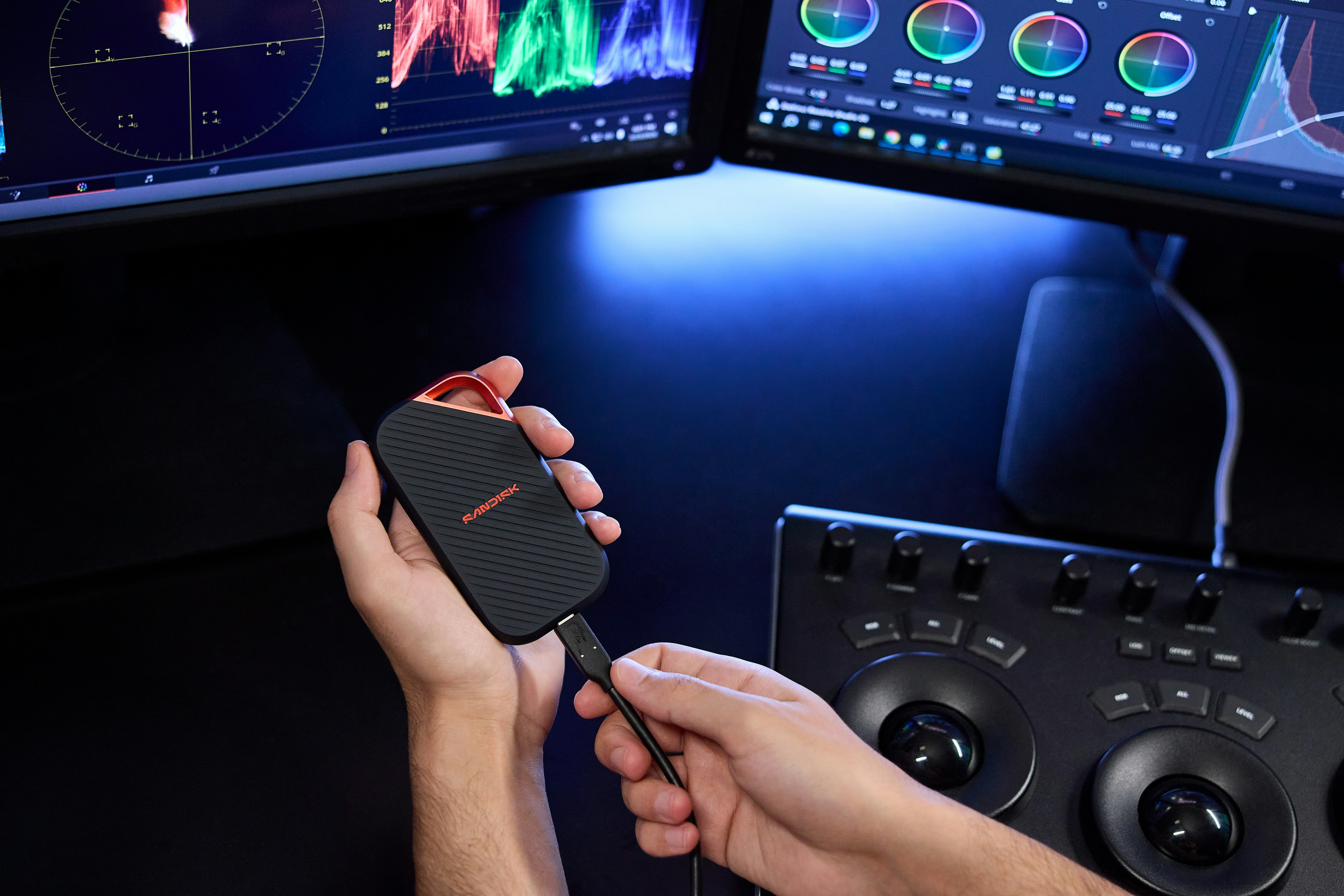 Person Connecting A Portable Ssd To A Video Editing Setup HD mobile wallpaper