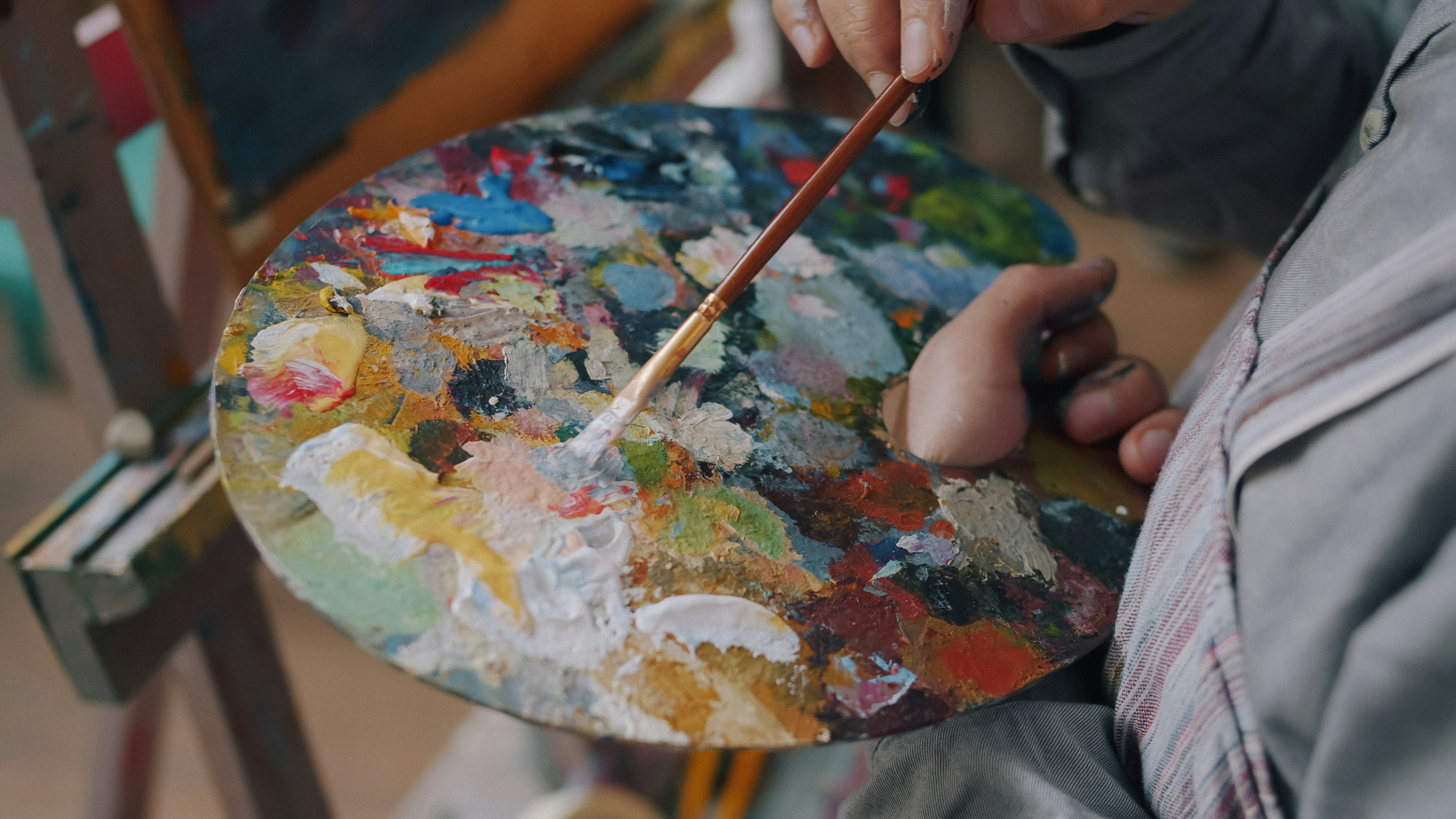 Close-up Of Man's Hand Artist Mixing Colors On Palette Then Painting Picture Working Alone Indoors. Creative Occupation And Fine Arts Tools Concept. HD mobile wallpaper