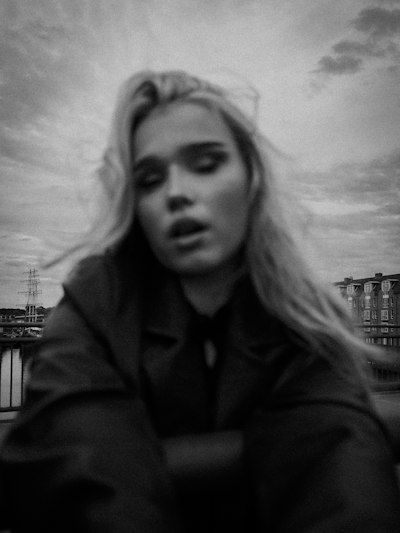 Eyes Closed Against The Gray Sky, Lost In A Grainy, Motion-blurred Dream wallpaper preview