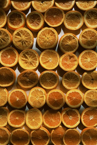 Many Orange Slices Arranged In A Grid Pattern On A Flat Surface wallpaper preview