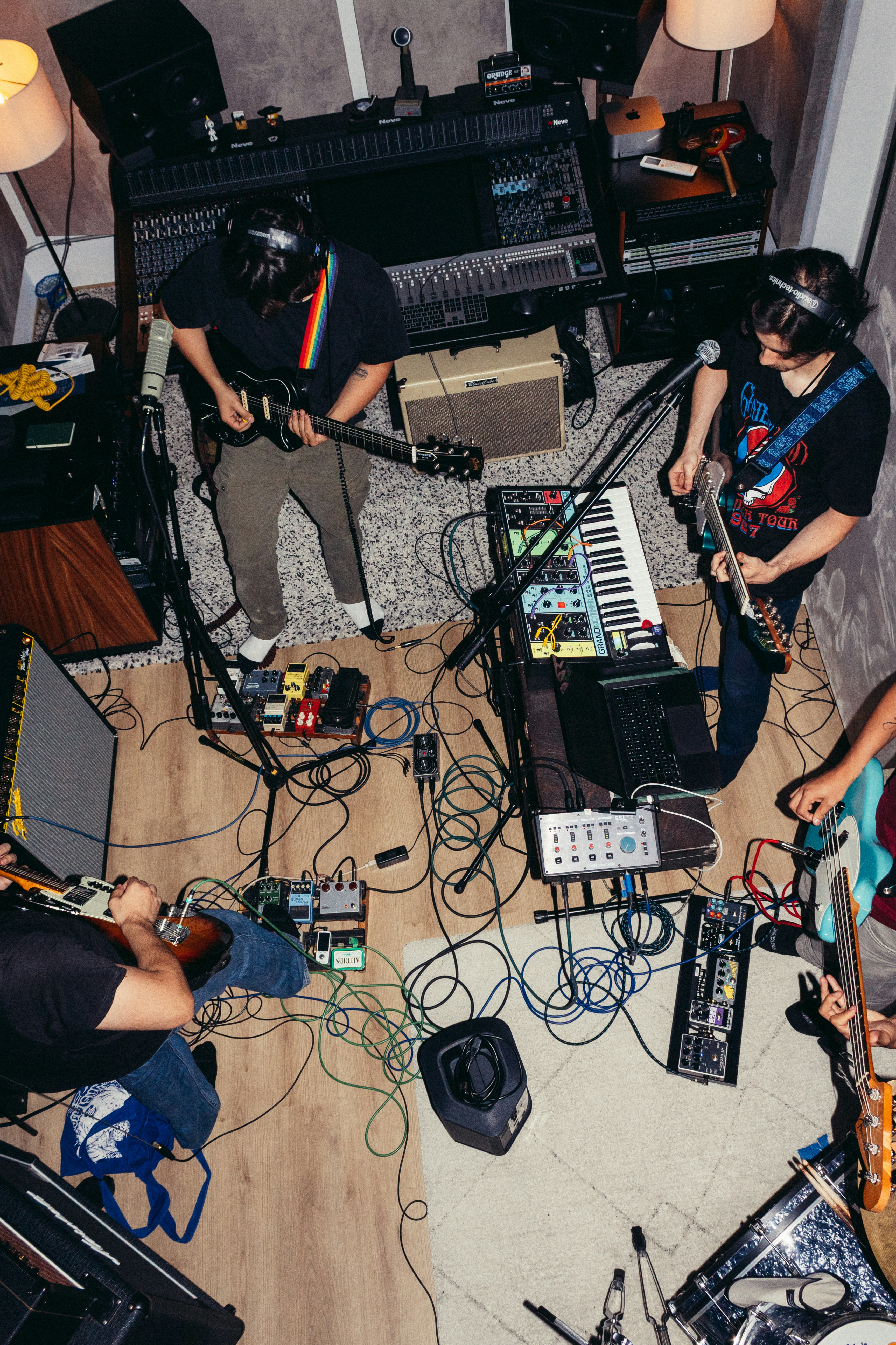 A Band Playing Instruments In A Recording Studio With Cables Scattered Across The Floor HD mobile wallpaper