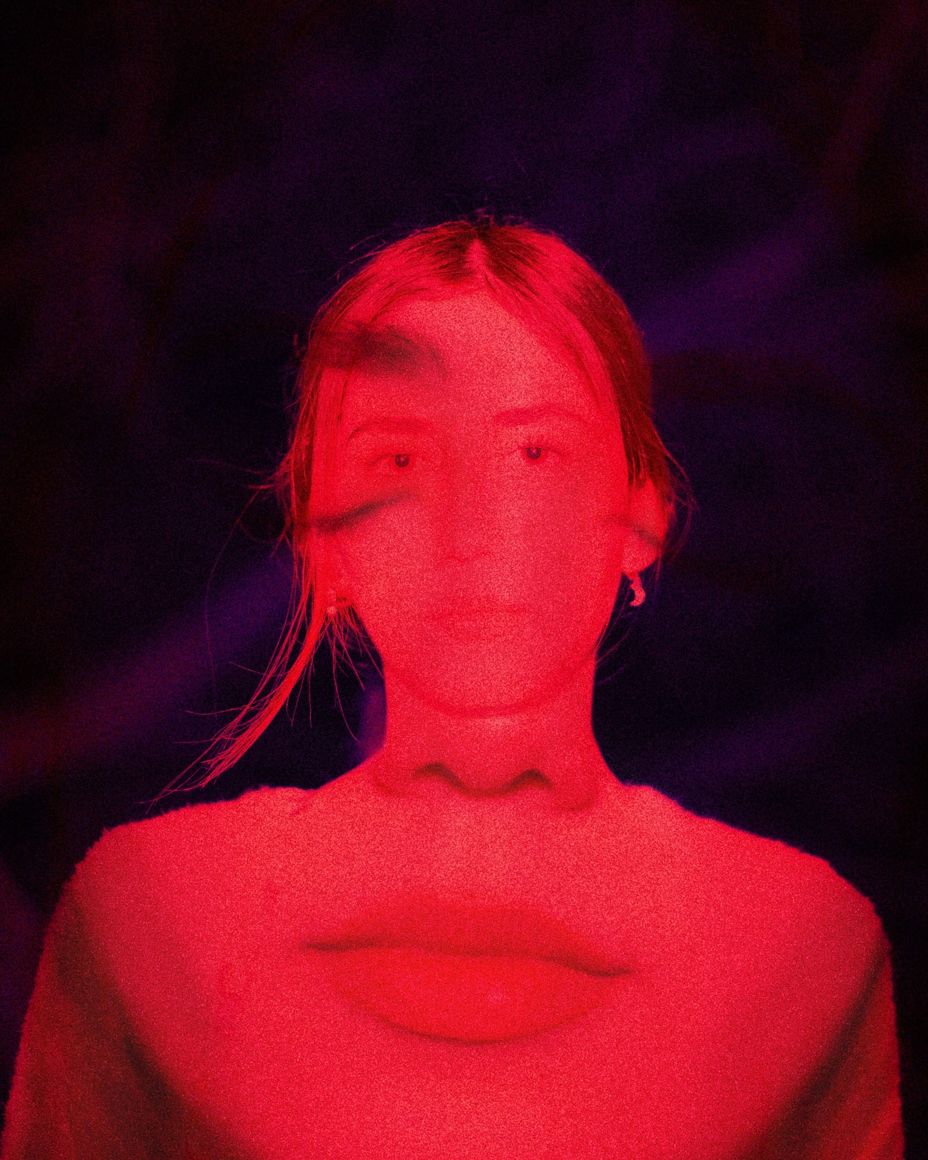 A Person With Long Hair In Bright Red Light Against A Dark Background HD mobile wallpaper