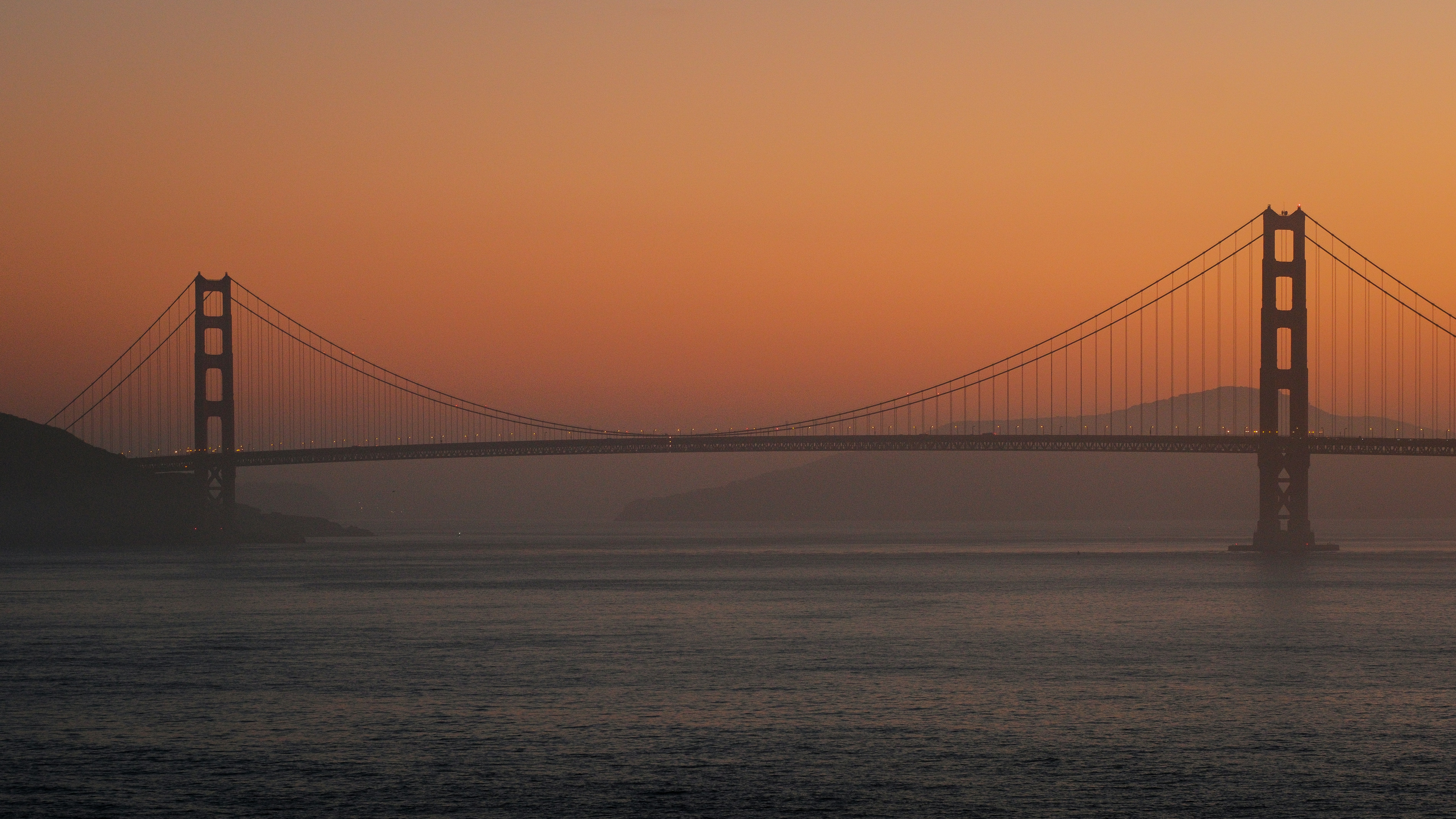 The Golden Gate Bridge In San Francisco Under A Warm Orange Sky HD mobile wallpaper