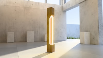 A Tall Wooden Floor Lamp With A Glowing Light Strip In A Concrete Room wallpaper preview