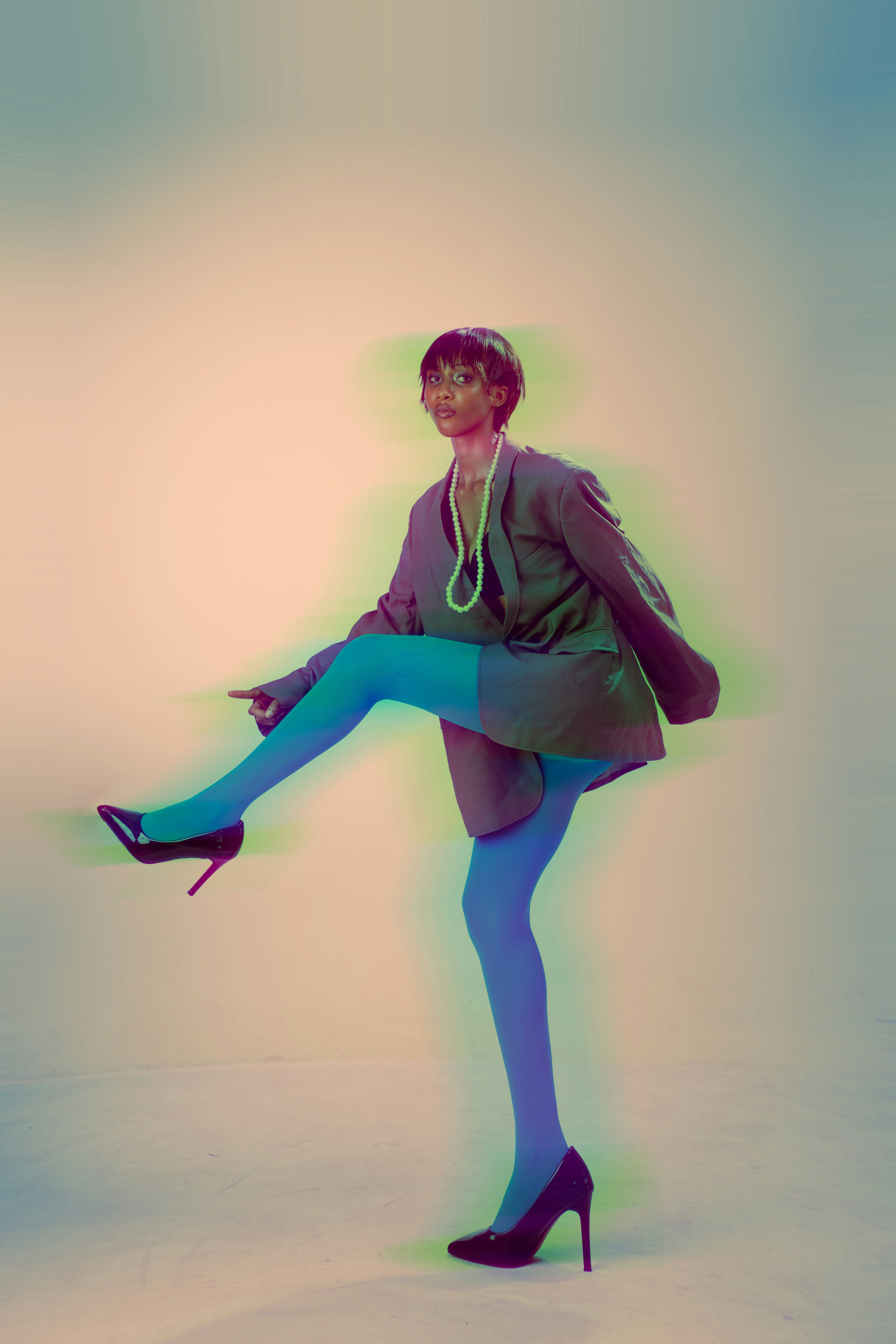 A Woman In A Blazer And Blue Tights Lifting One Leg With A Motion Blur Effect HD mobile wallpaper