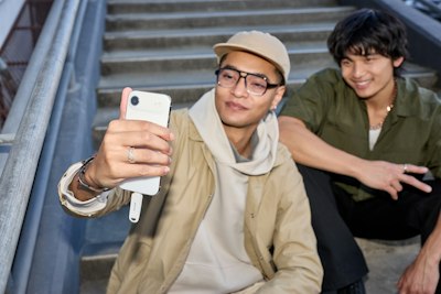 Two Young Men Taking A Selfie On Stairs wallpaper preview