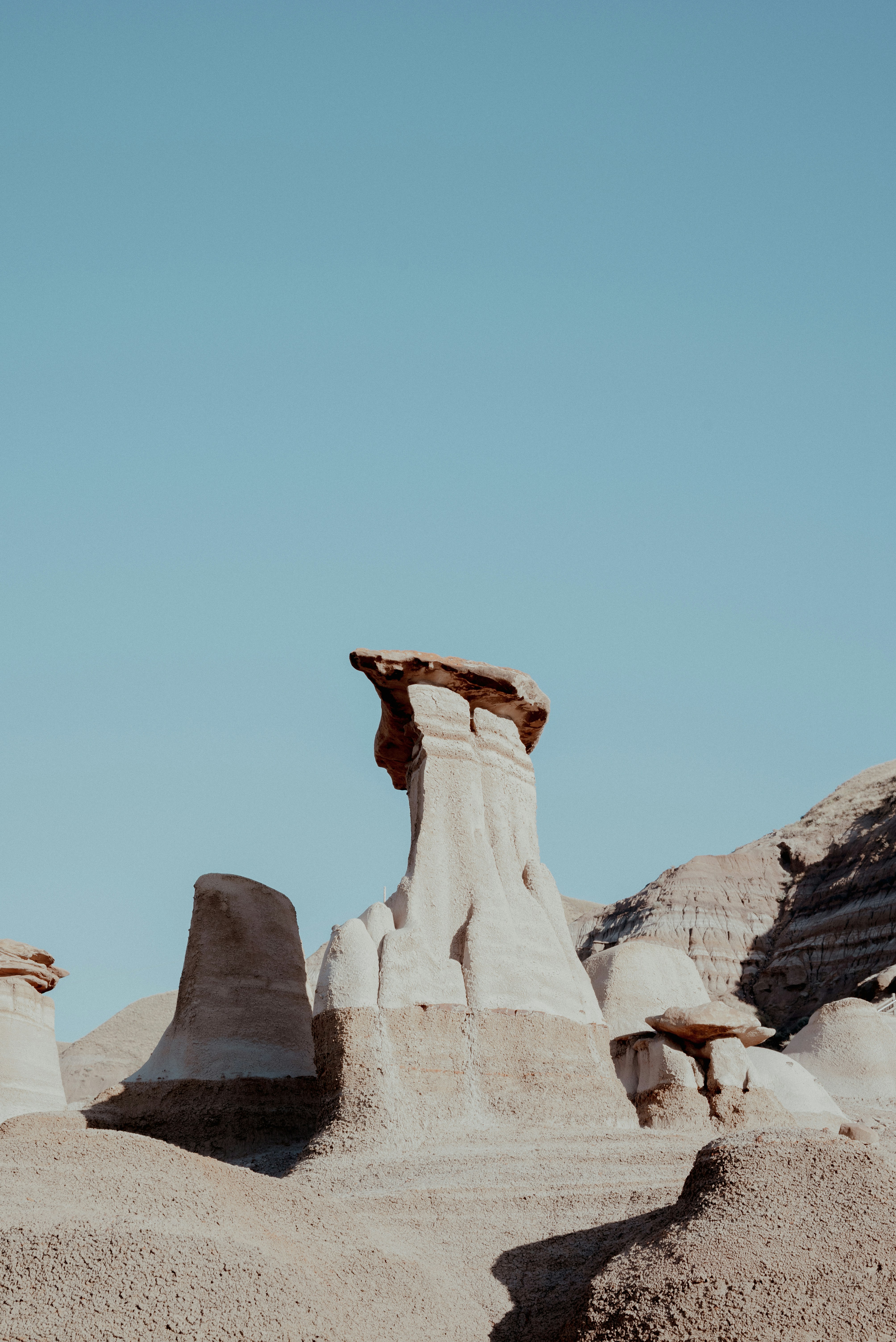 Eroded Sandstone Hoodoos Under A Clear Blue Sky In A Desert Landscape HD mobile wallpaper