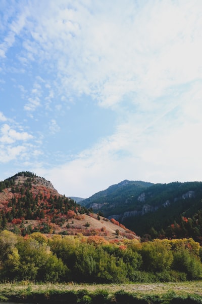 Green And Brown Mountains Under White Clouds And Blue Sky During Daytime wallpaper preview
