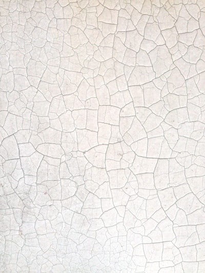 A Close Up Of A White Wall With Cracks In It wallpaper preview
