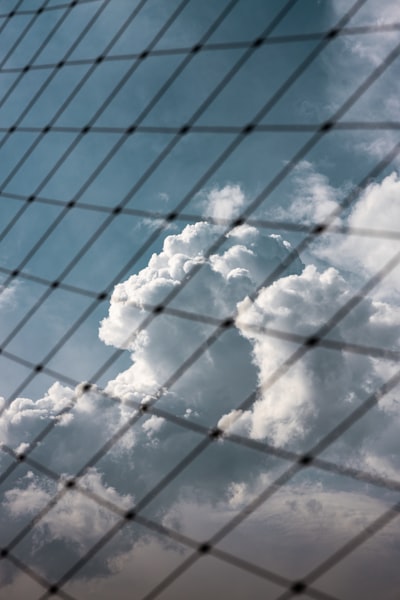 A Plane Flying Through A Cloudy Blue Sky wallpaper preview