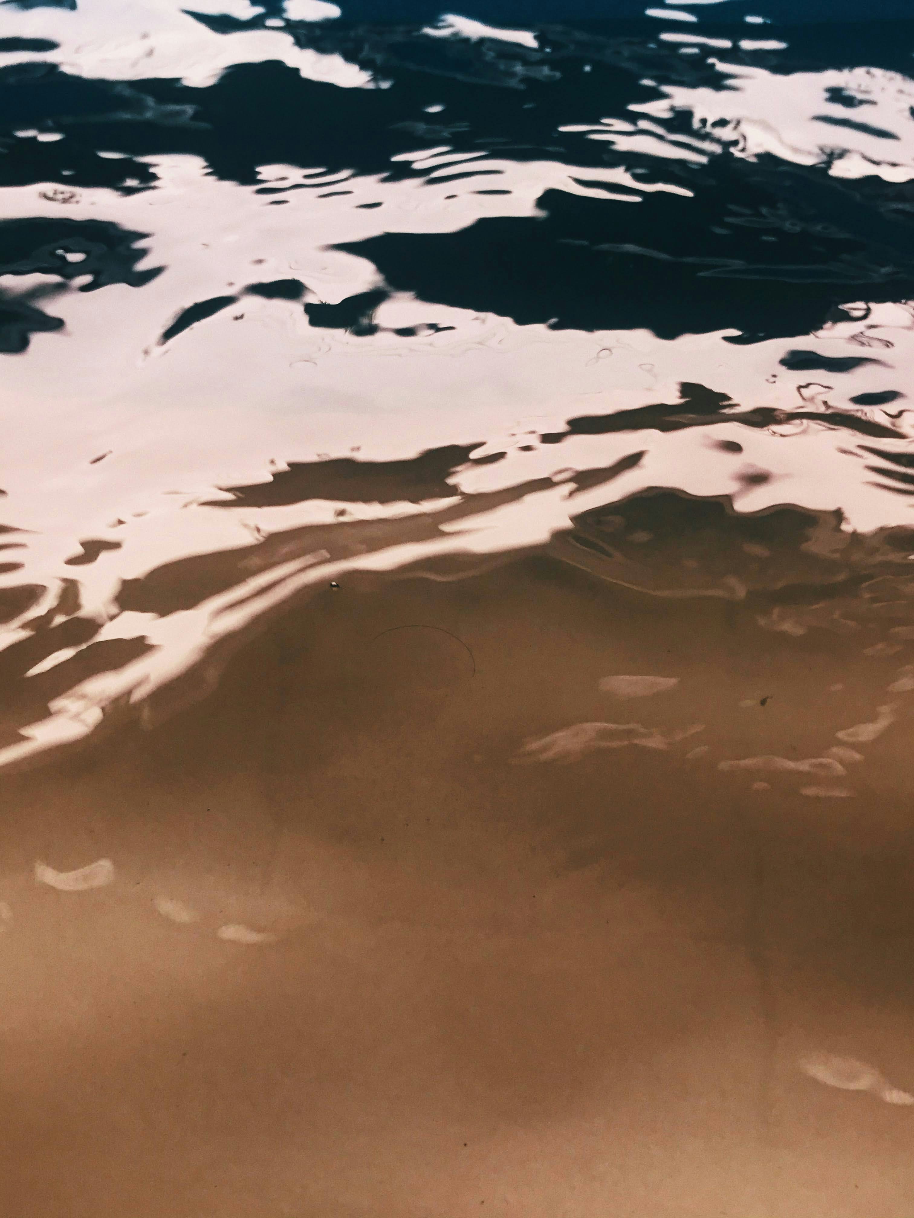 A Person Riding A Surfboard On Top Of A Body Of Water HD mobile wallpaper