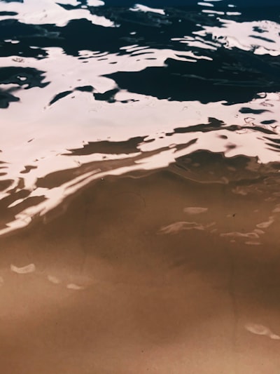 A Person Riding A Surfboard On Top Of A Body Of Water wallpaper preview