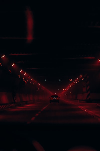 A Car Driving Down A Dark Street At Night wallpaper preview