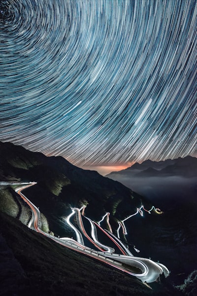 One Night Adventure In The Beautiful Passo Dello Stelvio In North Of Italy, Over 30 Road Bends, 18 Shots Of 30 Seconds For The Car Lights On The Road And 1 Hour Timelapse For The Startrail. wallpaper preview