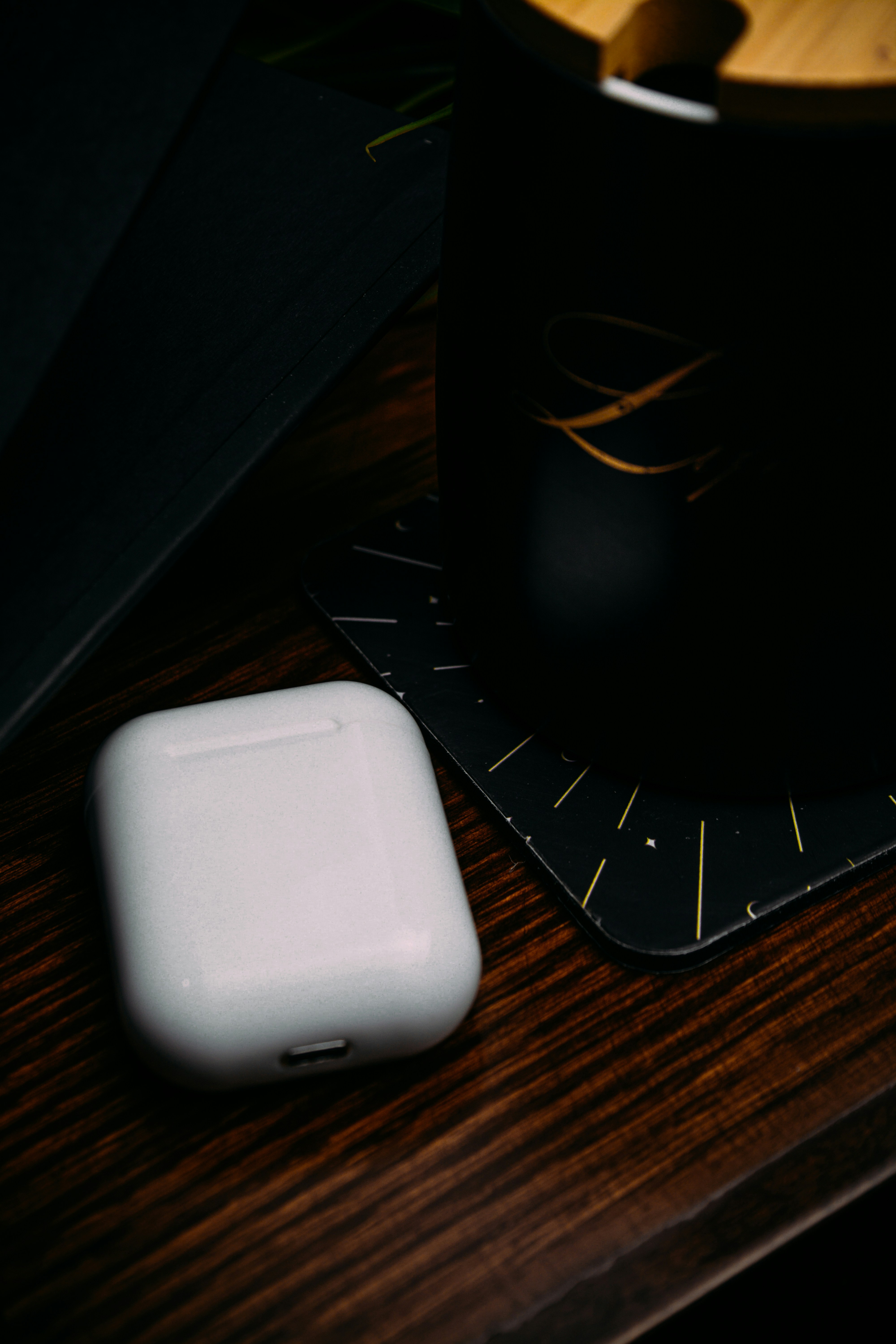 Airpods On Wood Table Beside Black Mug HD mobile wallpaper